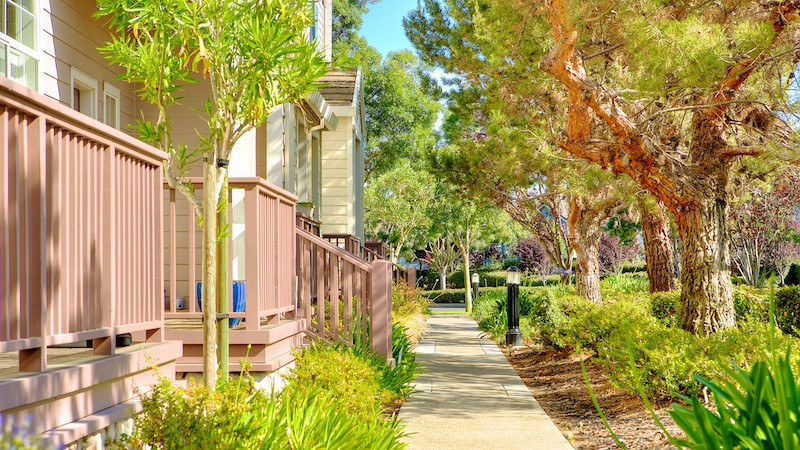 Townhomes in Shearwater Redwood shores porches and pine tree lined sidewalk
